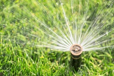 automatic irrigation system with sprinkler watering fresh lawn